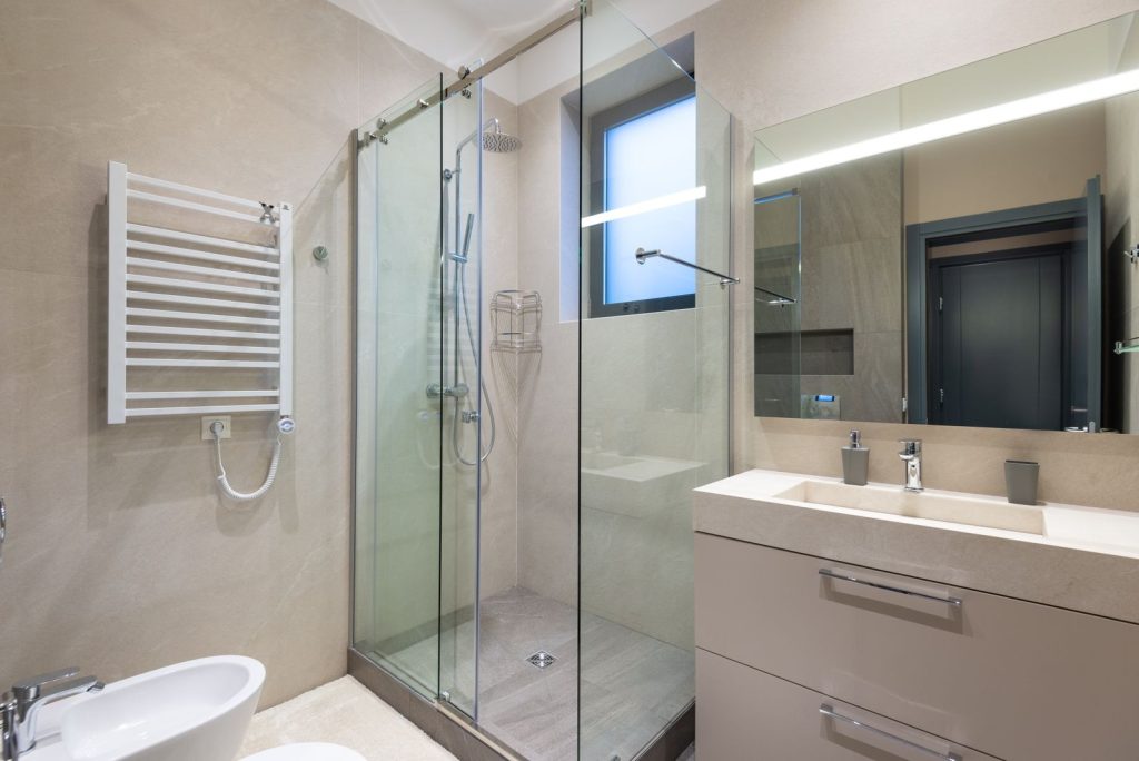 Modern home bathroom with glass shower cabin and vanity