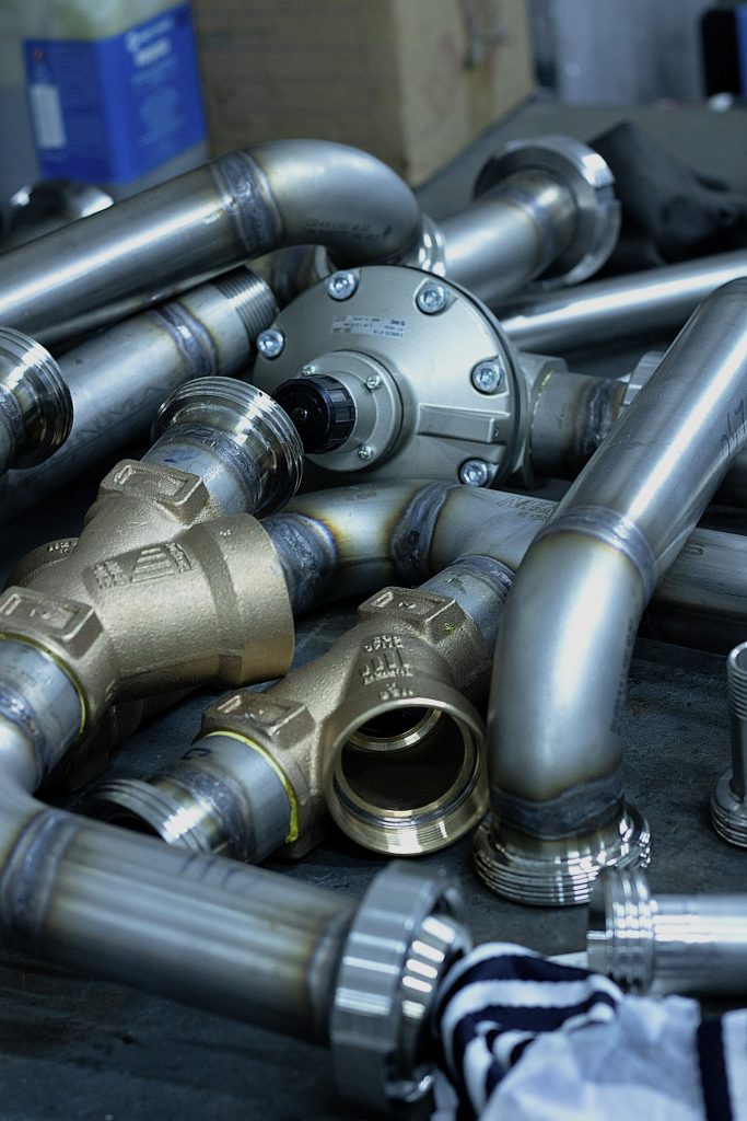 Assorted plumbing fittings and pipe sections laid out on a table