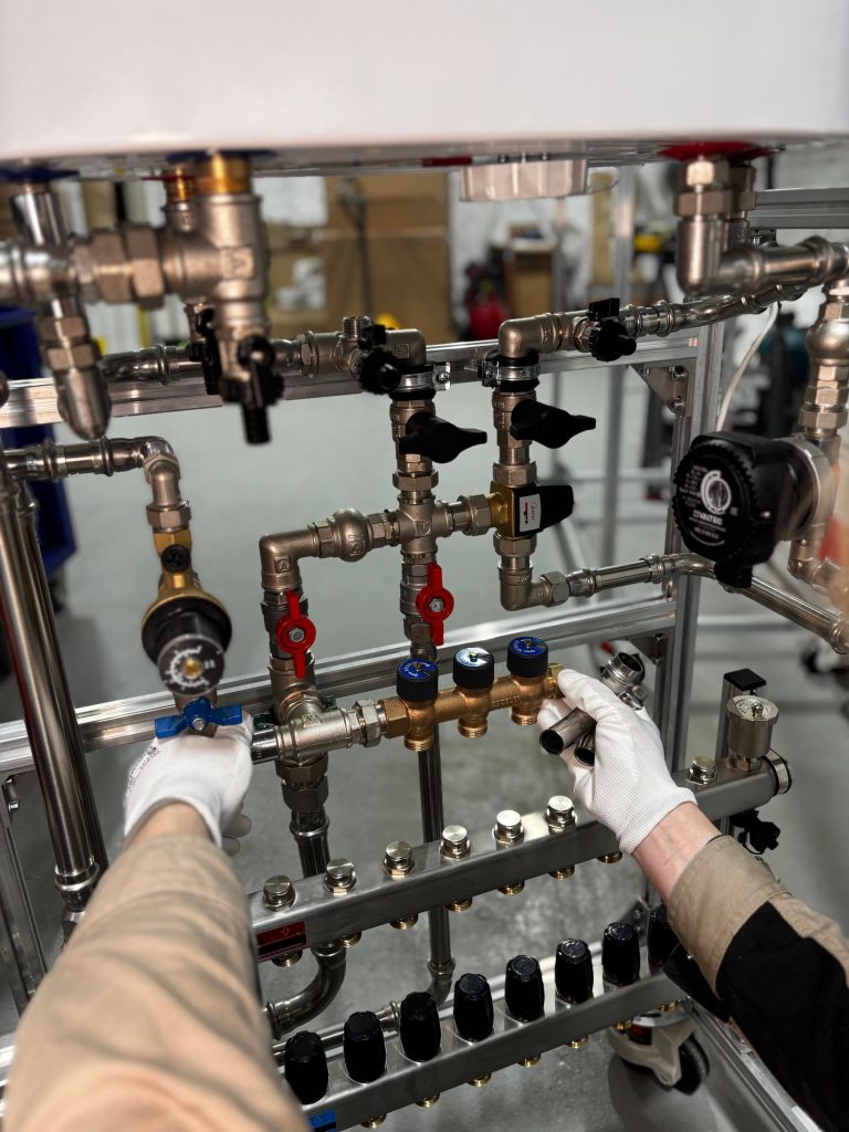 Technician adjusting valves on an industrial pipeline manifold